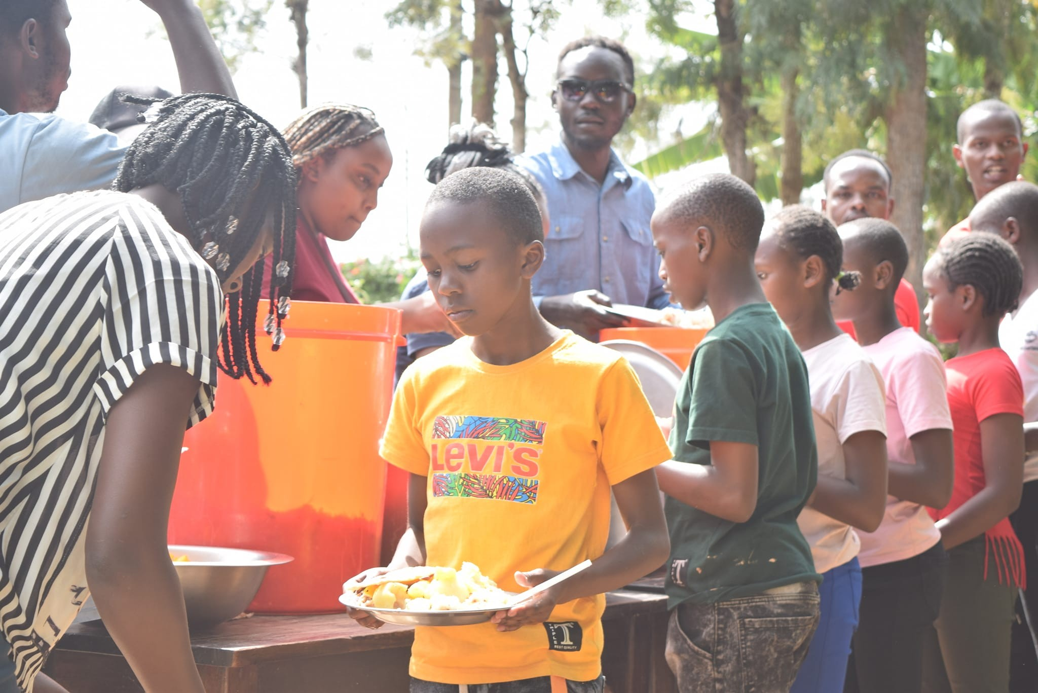 Children receiving food through the Danny Kioko Foundation